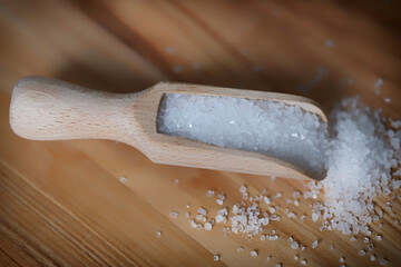 Selective focus. Sea salt in a wooden spatula.