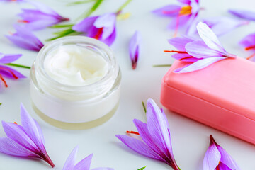 Obraz na płótnie Canvas Saffron soap and cream. Crocus flowers with red stigmas on a white background.