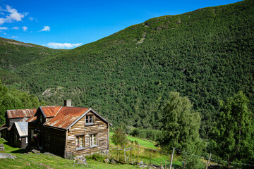 Fototapeta na wymiar Small cabin in a landscape with mountains in Norway