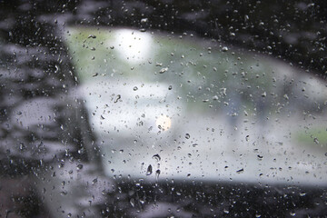 Car window with blurred raindrops