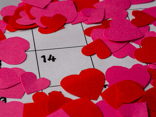 red and pink hearts on white calendar with numbers