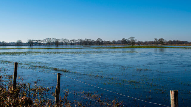 Vend&eacute;e, France; January 2, 2021: the marshes of blue colors are frozen, winter is here, a superb day with a magnificent sky, not far from Challans.

