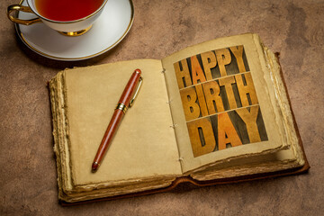 happy birthday romantic greeting card - word abstract in letterpress wood type in a retro journal with a cup of tea