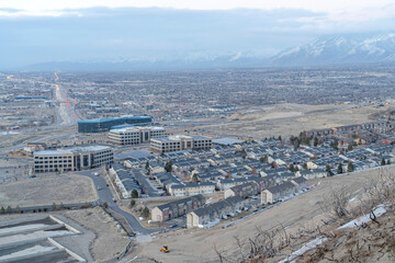 Aerial view of neighborhood town with roads amidst houses and town buildings