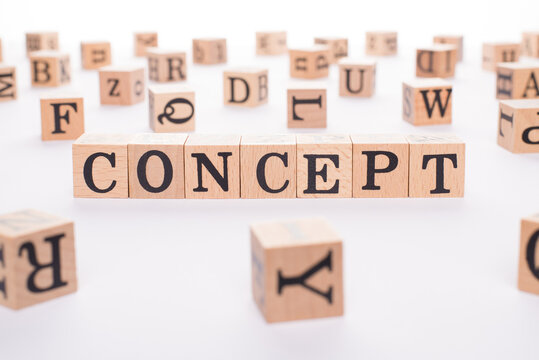 Close up photo of wooden blocks cubes making showing word concept on white table
