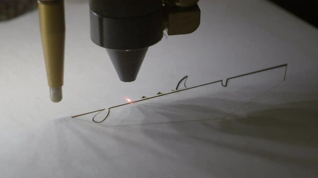 Laser cutter working on wood closeup