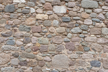 Texture of an old ancient weathered stone wall