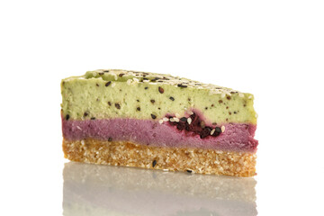 Piece of raw food cake with kiwi and bramble on a white plate.