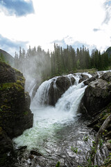 Fototapeta na wymiar Rjukandefoss waterfall with dust and a rock