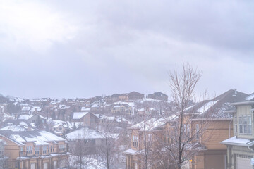 Fototapeta na wymiar Foggy winter day on a neighborhood with multi storey houses under cloudy sky
