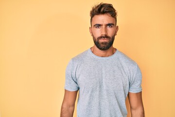 Obraz premium Young hispanic man wearing casual clothes with serious expression on face. simple and natural looking at the camera.