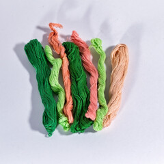 Multicolored skeins of thread for embroidery isolate on a white background.