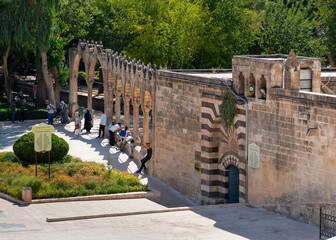 Sanliurfa/Turkey- September 15 2020: People enjoy near the wall of Halil-ur Rahman Mosque.