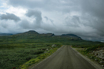 Gravel road with mountains in the distance