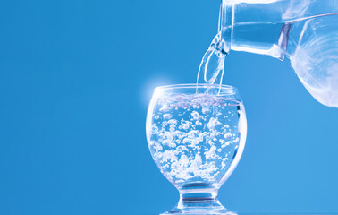water glass and water bottle with water filling and blue background