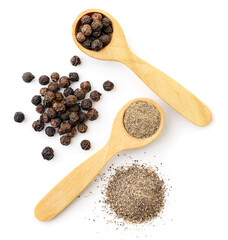 Black peppercorns and ground in a wooden spoon on a white background, isolated. The view from top