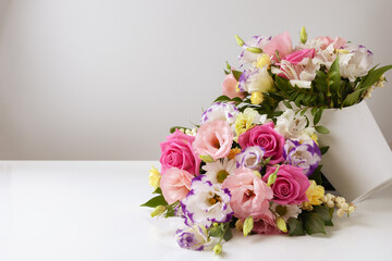 mock up two bouquets of different sizes of roses, daisies, lisianthus, chrysanthemums, unopened buds on a white background, one bouquet lies on top of the other