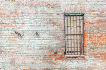 window in an old abandoned industrial brick building close up