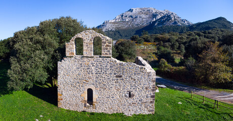 View from a drone of the ruins of the hermitage of San Julian in the Liendo Valley in Cantabria, Spain, Europe