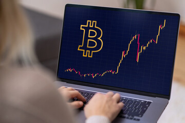 Bitcoin BTC cryptocurrency stock market growth in a laptop's pc screen. Watching increasing personal business investment trading success, exchange rates and rise or fall charts with coffee on table.