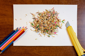 Colored pencils, shavings and a stationery knife