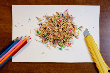 Colored pencils, shavings and a stationery knife
