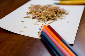 Colored pencils, shavings and a stationery knife