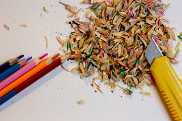 Colored pencils, shavings and a stationery knife