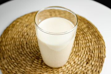 Fresh milk in a glass cup, top view.