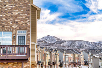 Real estate landscape with townhouses overlooking snow dusted Wasatch Mountain