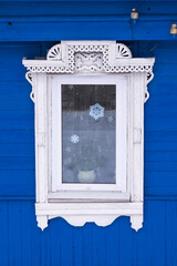 Gingerbread wood trims. Window framed white wooden decoration.