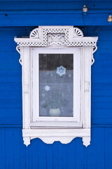 Fototapeta na wymiar Gingerbread wood trims. Window framed white wooden decoration.