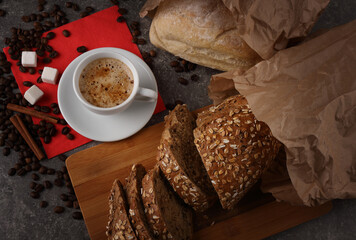 A cup of coffee and bread on a granite texture