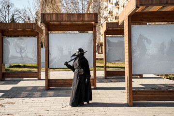 plague doctor stands at empty stands