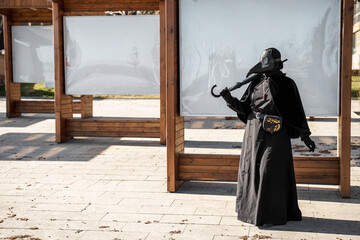 plague doctor stands at empty stands