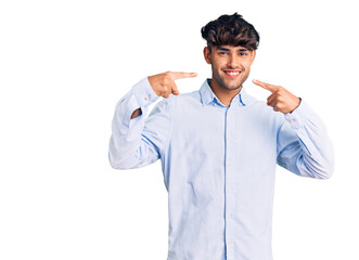 Young hispanic man wearing casual shirt smiling cheerful showing and pointing with fingers teeth and mouth. dental health concept.