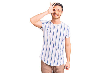 Handsome young man with bear wearing casual clothes smiling happy doing ok sign with hand on eye looking through fingers