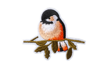 Bullfinch on a branch embroidered patch isolated on white background