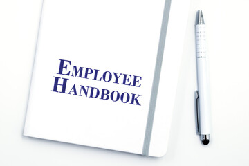 White Employee Handbook or manual with White pen on white table surface - personnel management...