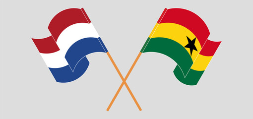 Crossed and waving flags of the Netherlands and Ghana