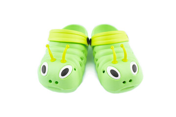 Pair of bright green children's clogs isolated on the white background.