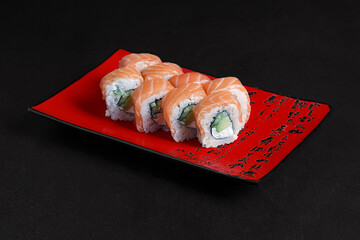 Asian cuisine dish, delicious sushi, sushi on a black background, roll you net on a black background