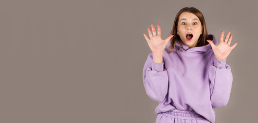 Portrait of young woman with shocked facial expression