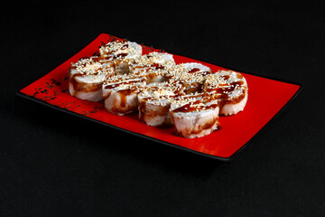 Asian cuisine dish, delicious sushi, sushi on a black background, roll you net on a black background