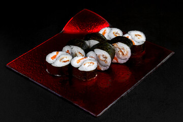 Asian cuisine dish, delicious sushi, sushi on a black background, roll you net on a black background,