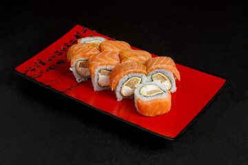 Asian cuisine dish, delicious sushi, sushi on a black background, roll you net on a black background,