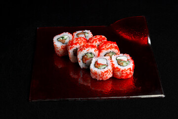 Asian cuisine dish, delicious sushi, sushi on a black background, roll you net on a black background,