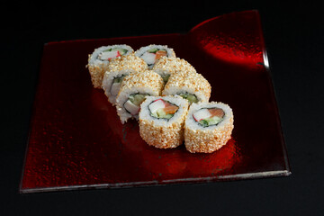 Asian cuisine dish, delicious sushi, sushi on a black background, roll you net on a black background,