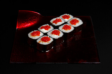 Asian cuisine dish, delicious sushi, sushi on a black background, roll you net on a black background,
