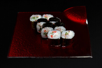 Asian cuisine dish, delicious sushi, sushi on a black background, roll you net on a black background,
